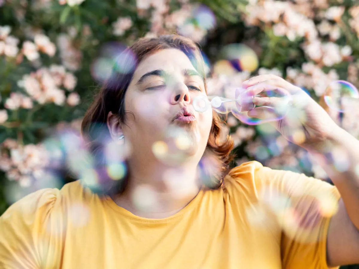 A disabled woman blowing bubbles